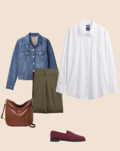 A flat lay outfit featuring a white button-up shirt, olive-green trousers, a denim jacket, a brown leather shoulder bag, and burgundy loafers on a neutral beige background.
